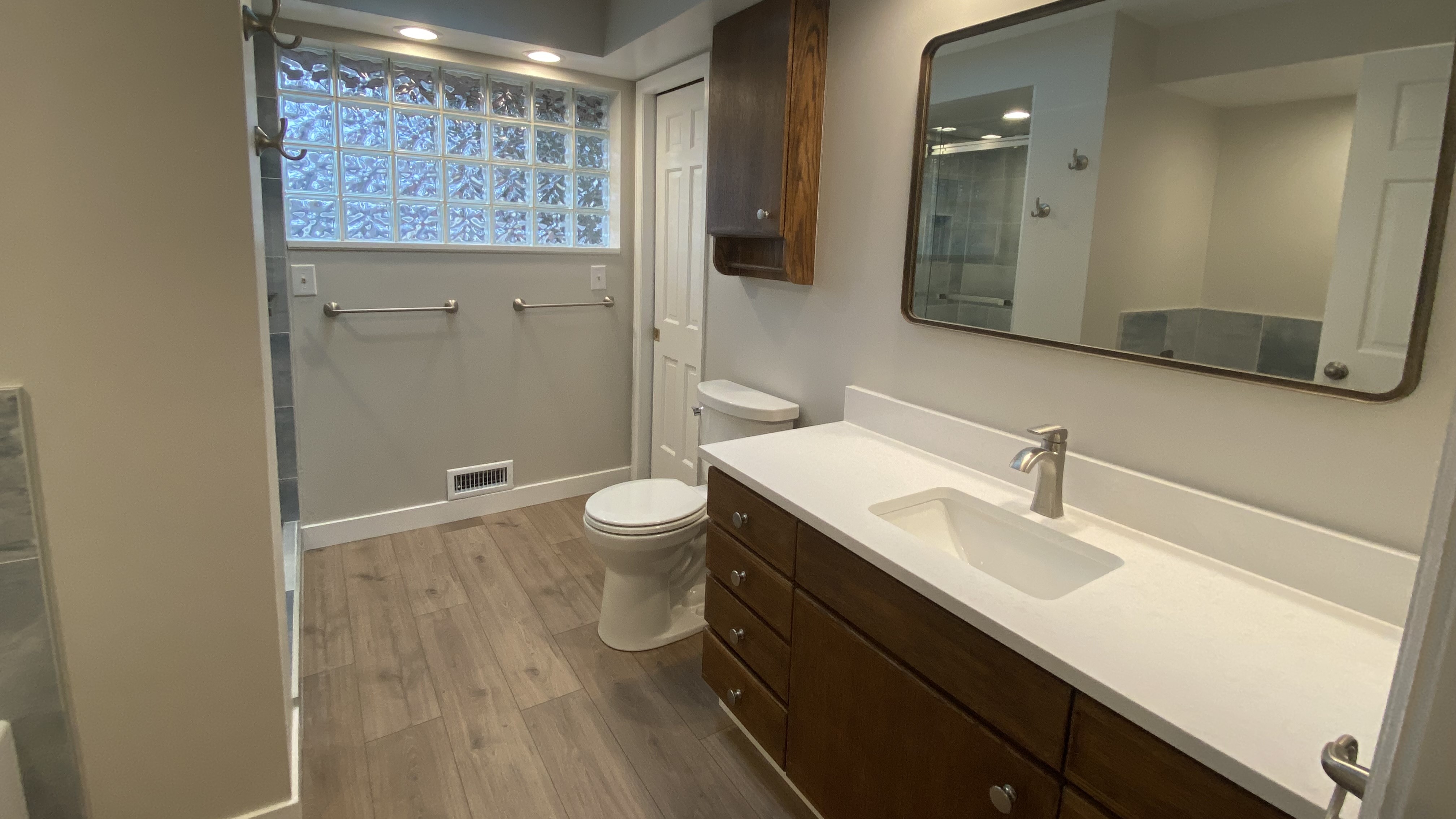Refinished cabinetry w/ (Glacier White) quartz countertop, 12mm vinyl flooring